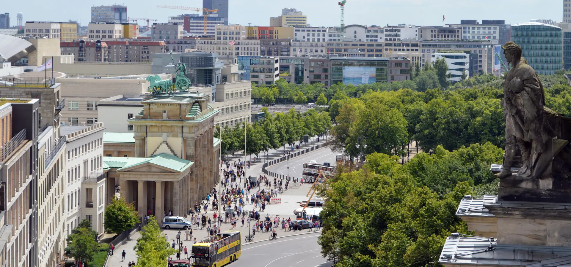 The Brandenburg Gate in central Berlin seen on a summer afternoon from the roof terrace of the Reichstag building.